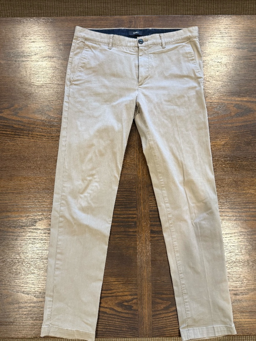 Theory men’s chino pants in a classic khaki/beige color, tagged size 32